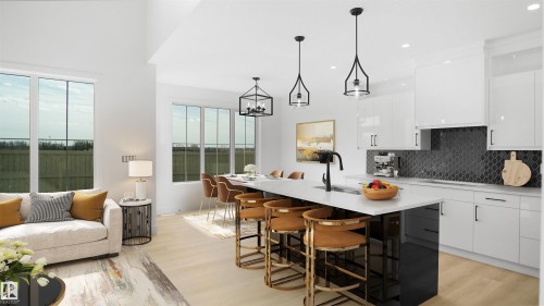 Modern kitchen featuring a large island with sink, white shaker cabinetry, black backsplash tiling, and light wood-finish flooring - 803 30 Avenue, Edmonton, AB 