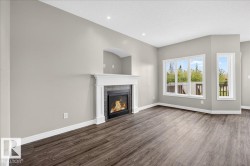 Living area featuring an electric fireplace with a white mantel and dark gray tile surround - 