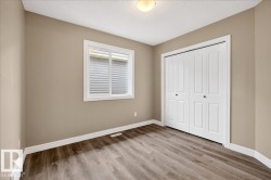 Room featuring wood-finish flooring, neutral wall tones, and white trim - 