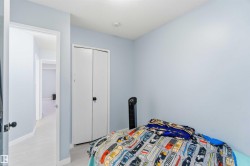 Room featuring light blue walls, white trim, and light wood-finish flooring - 