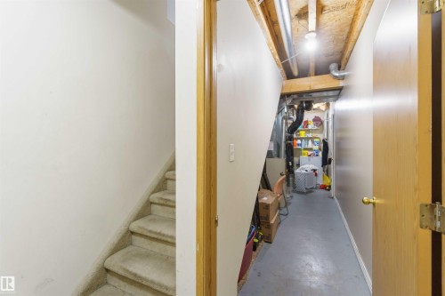 Carpeted staircase with light-toned walls - 8 15128 22 Street, Edmonton, AB 