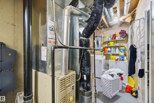 Utility area with exposed ceiling joists and concrete flooring - 8 15128 22 Street, Edmonton, AB 