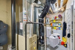 Utility area with exposed ceiling joists and concrete flooring - 