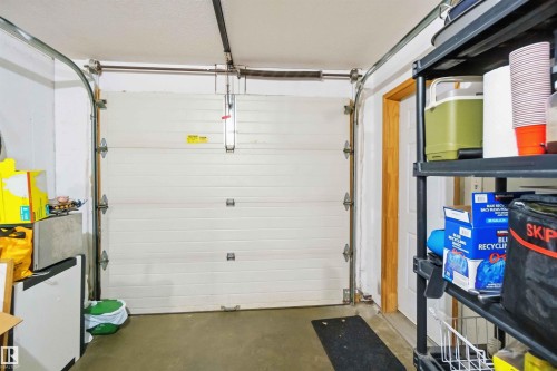 Attached garage featuring a white sectional overhead door - 8 15128 22 Street, Edmonton, AB 