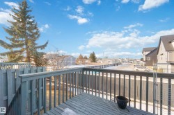 Spacious outdoor deck with painted wood railing - 