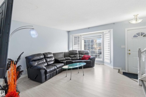 Light-toned wood-finish flooring complements the pastel wall color - 8 15128 22 Street, Edmonton, AB 