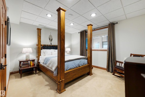 Carpeted room with recessed lighting and a window featuring dark wood trim and drapery - 28125 Highway 587, Rural Red Deer County, AB 