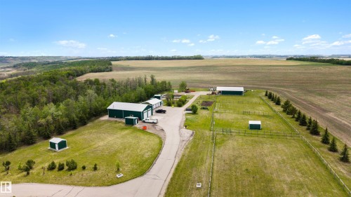 Expansive property featuring multiple outbuildings, fenced pasture areas, and a paved drive - 28125 Highway 587, Rural Red Deer County, AB 