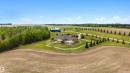 Expansive rural property featuring a two-story residence with a walk-out lower level and multiple upper-story balconies - 28125 Highway 587, Rural Red Deer County, AB 