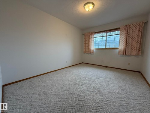 PHOTO OF THE MAIN FLOOR 2nd BEDROOM SOON AS YOU WALK INTO THE UNIT! BUT...IT DOES NOT HAVE A CLOSET! - 102 4610 50 Avenue, Stony Plain, AB 