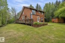 Wood-sided residence featuring a multi-level deck, a pitched roofline, and a garden bed - 61 Stang Cres, Rural Two Hills County, AB 