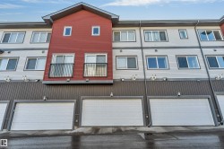 Multi-level building with red and gray horizontal siding - 