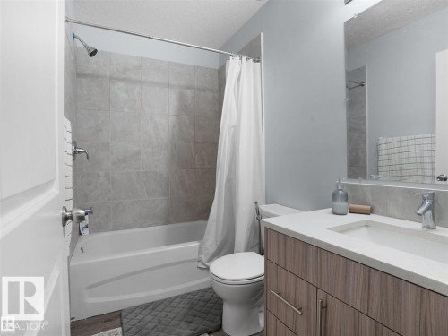 Bathroom featuring a tub/shower combination with tile surround - 207 41 Avenue, Edmonton, AB 