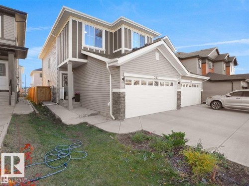 Modern two-story residence with a gray siding exterior, white trim accents, and a stone veneer foundation - 207 41 Avenue, Edmonton, AB 