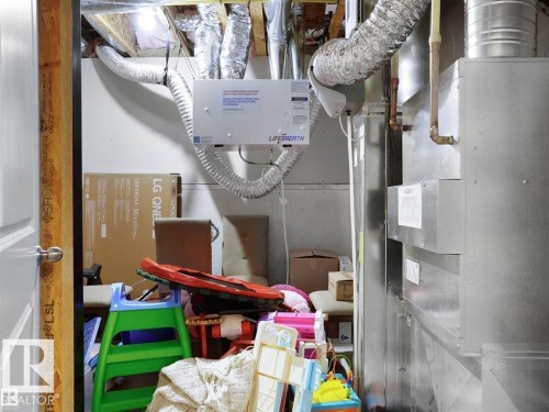 Utility room featuring a heat recovery ventilation unit, extensive ductwork, and a furnace system - 207 41 Avenue, Edmonton, AB 