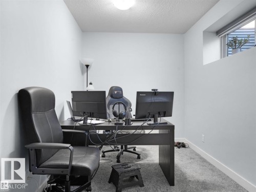 Bright room featuring light grey walls and grey carpet flooring - 207 41 Avenue, Edmonton, AB 
