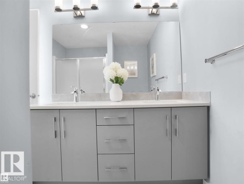 Double vanity with gray cabinetry, brushed nickel hardware, and light-toned countertops - 207 41 Avenue, Edmonton, AB 