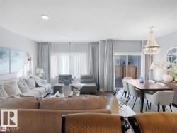 Open-concept living and dining areas featuring wood-finish flooring, recessed lighting, and a sliding glass patio door - 