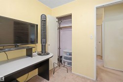 Room with light yellow walls and textured carpeting - 