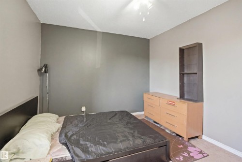 Room featuring a textured ceiling, a ceiling fan with light fixture, and neutral painted walls - 17 Lakewood Village, Edmonton, AB 