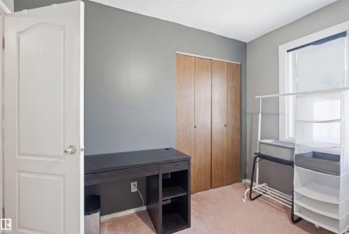 Room featuring neutral wall paint and light-colored carpeting - 17 Lakewood Village, Edmonton, AB 