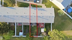Attached townhome featuring a private rear yard with a small patio area and perimeter fencing - 