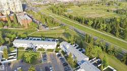 Aerial perspective showcasing a multi-unit residential property with private outdoor spaces - 