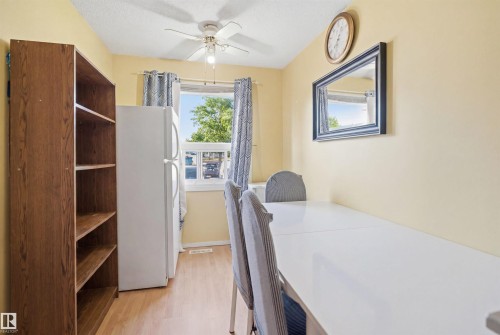 Bright room featuring wood-finish flooring and a ceiling fan - 17 Lakewood Village, Edmonton, AB 