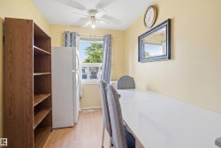 Bright room featuring wood-finish flooring and a ceiling fan - 