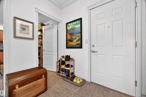 Foyer with tiled flooring and white paneled entry door - 304 10116 80 Avenue, Edmonton, AB 