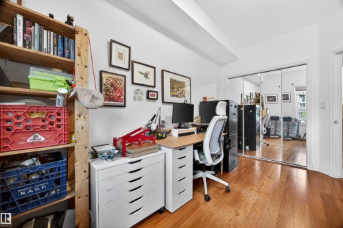 Room featuring warm wood-finish flooring and white walls - 304 10116 80 Avenue, Edmonton, AB 