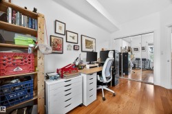 Room featuring warm wood-finish flooring and white walls - 