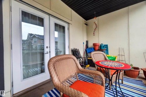 Outdoor patio with solid privacy walls, covered ceiling, and glass French doors - 304 10116 80 Avenue, Edmonton, AB 