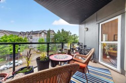 Private balcony featuring a glass railing and concrete flooring - 
