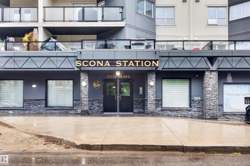 Modern building exterior featuring a stone facade and prominent entry - 304 10116 80 Avenue, Edmonton, AB 