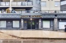 Modern building exterior featuring a stone facade and prominent entry - 304 10116 80 Avenue, Edmonton, AB 