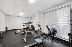 Dedicated fitness space featuring rubber flooring, recessed lighting, and white walls - 
