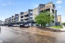 Contemporary mixed-use building featuring commercial ground-floor retail and residential units above - 304 10116 80 Avenue, Edmonton, AB 