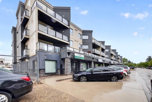 Modern multi-story building featuring stacked balconies with glass railings - 304 10116 80 Avenue, Edmonton, AB 