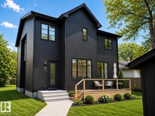 Modern two-story residence featuring black vertical siding and contrasting black-framed windows - 9243 148 Street, Edmonton, AB 