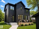 Modern two-story residence featuring black vertical siding and contrasting black-framed windows - 9243 148 Street, Edmonton, AB 