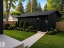 Modern outbuilding with vertical black siding and an asphalt shingle roof - 9243 148 Street, Edmonton, AB 