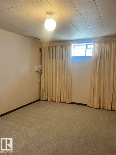 Carpeted room featuring a drop ceiling with recessed lighting - 15003 81 Street, Edmonton, AB 