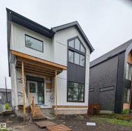 Modern architectural design featuring vertical white siding and black paneling accents - 