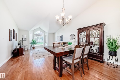 Bright interior space featuring vaulted ceilings, wood-finish flooring, and a large bay window - 50 303 Twin Brooks Drive Nw, Edmonton, AB 