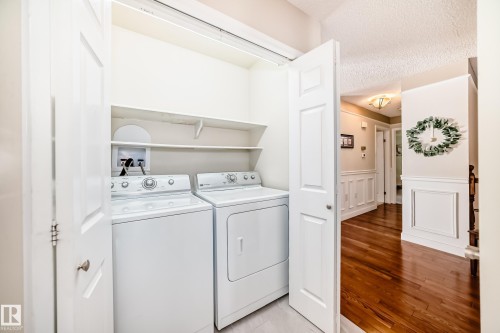 Dedicated laundry closet with shelving - 50 303 Twin Brooks Drive Nw, Edmonton, AB 