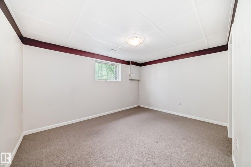 Carpeted room with a drop ceiling featuring recessed lighting - 50 303 Twin Brooks Drive Nw, Edmonton, AB 