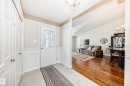 Entryway featuring a decorative glass paneled door, wainscoting, and tile flooring - 50 303 Twin Brooks Drive Nw, Edmonton, AB 