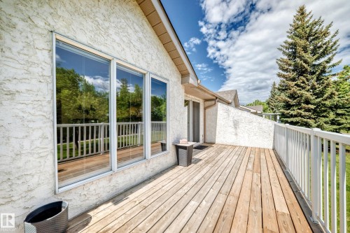 Spacious outdoor deck featuring natural wood planks and white railings - 50 303 Twin Brooks Drive Nw, Edmonton, AB 