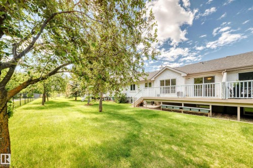 Expansive green lawn with mature trees and a fenced boundary - 50 303 Twin Brooks Drive Nw, Edmonton, AB 